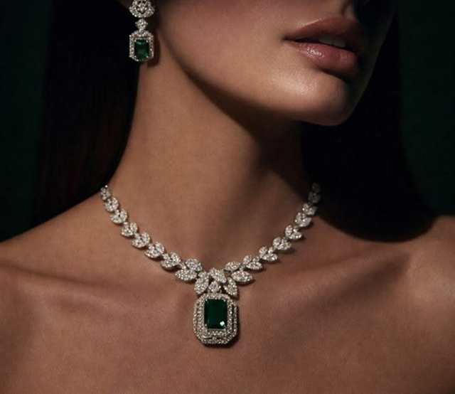 Customer wearing an emerald diamond necklace and earrings